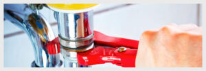 Plumber using wrench for plumbing repair