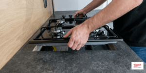 plumber repairing gas stove