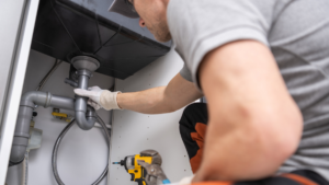 Plumber in Brisbane fixing an emergency water leak.